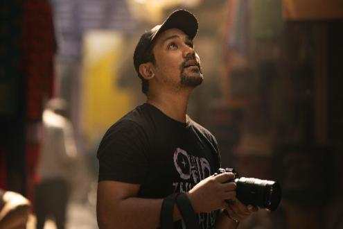 Image of Arjun Kumar, a young entrepreneur, sharing his experience with Circle of Shiva. The text reads: ‘Absolutely love the designs! The quotes and symbols on the T-shirt feel so meaningful. Plus, the fabric is super soft and comfortable. Feels like it’s made for me.’ The background features a soft Yellow Green gradient.